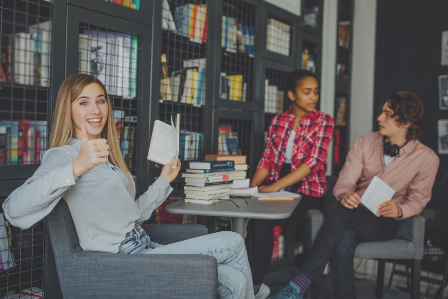 Estudantes a trabalhar em projetos financeiros colaborativos numa sala de estudo moderna